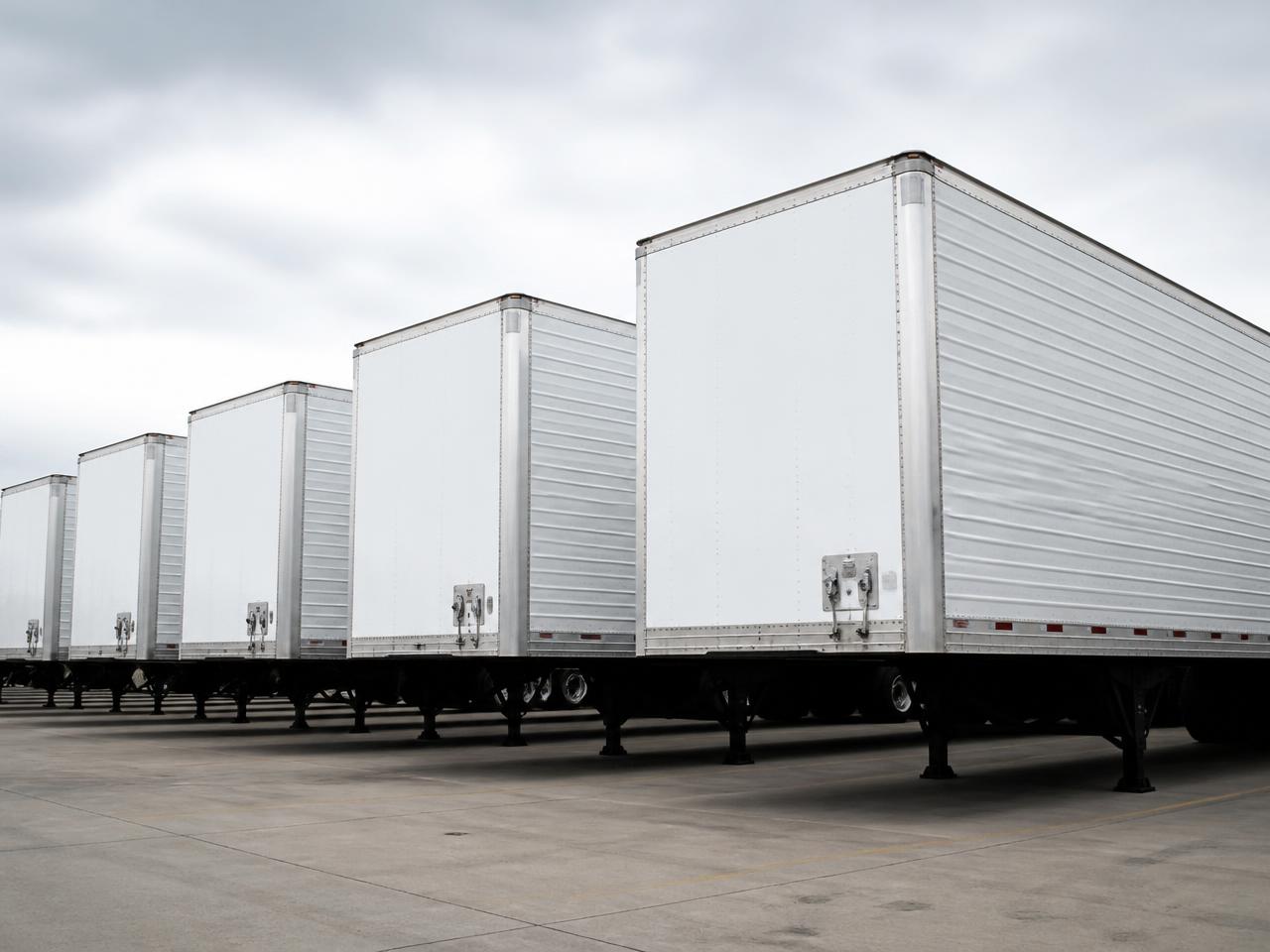 Row of commercial freight trailers parked at a logistics yard